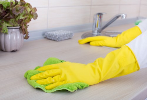 Technician performing upholstery cleaning on a couch